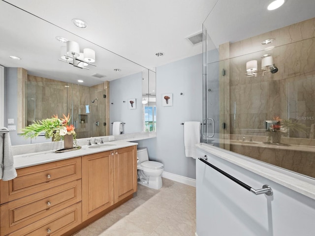 bathroom with vanity, a shower with door, and toilet