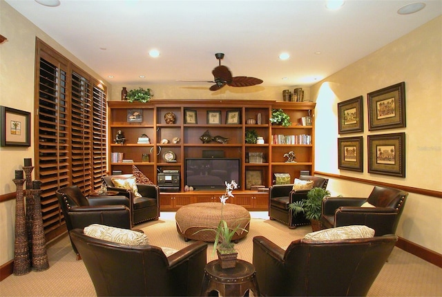 sitting room featuring ceiling fan and light colored carpet