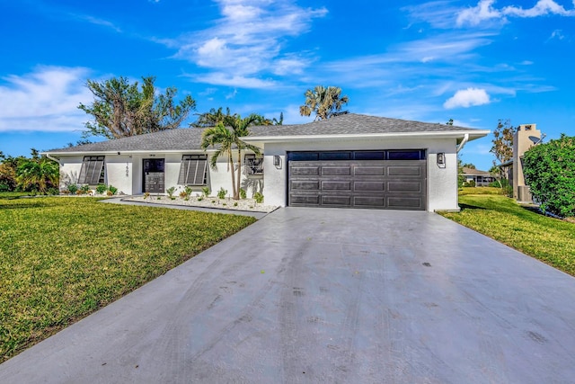 ranch-style home featuring a garage and a front lawn