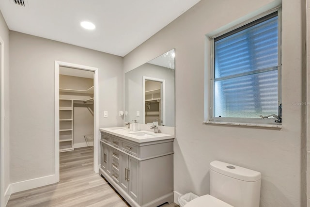 bathroom featuring vanity, toilet, and hardwood / wood-style floors