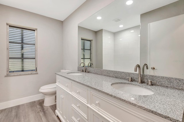 bathroom with vanity, hardwood / wood-style flooring, and toilet