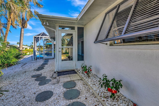 view of exterior entry featuring a patio