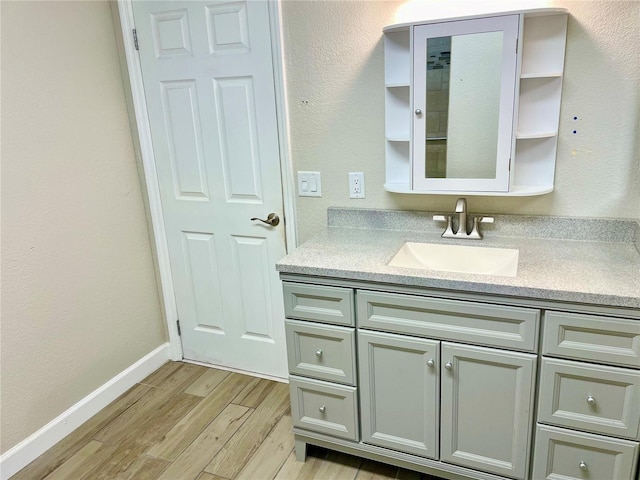 bathroom featuring vanity and hardwood / wood-style floors