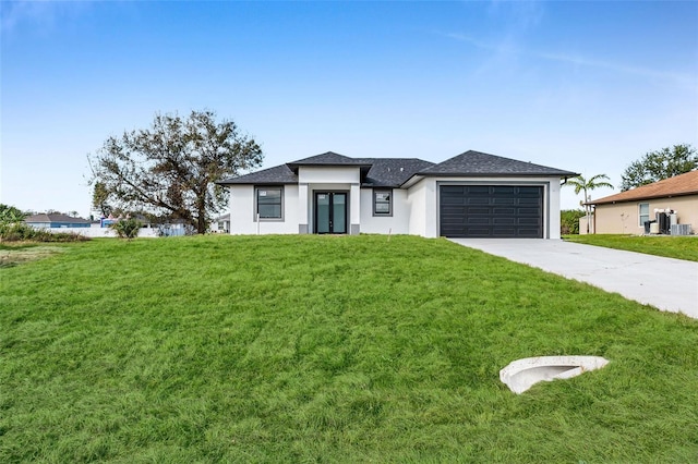 view of front of house with a garage and a front yard