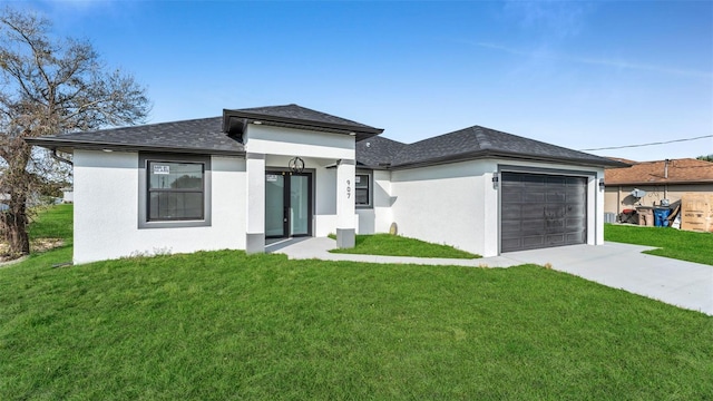 prairie-style house featuring a garage, driveway, a front lawn, and stucco siding