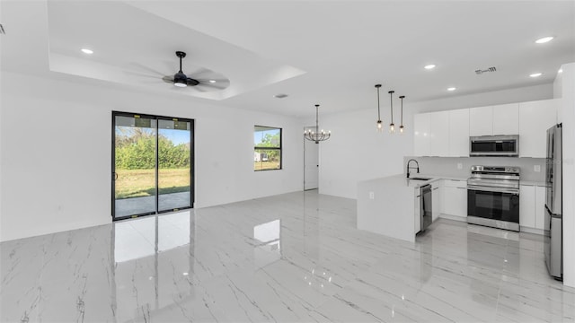 kitchen with modern cabinets, stainless steel appliances, light countertops, and open floor plan