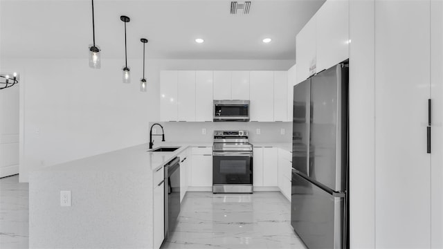 kitchen featuring visible vents, white cabinets, modern cabinets, stainless steel appliances, and pendant lighting