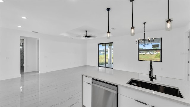 kitchen with white cabinets, a sink, hanging light fixtures, and dishwasher