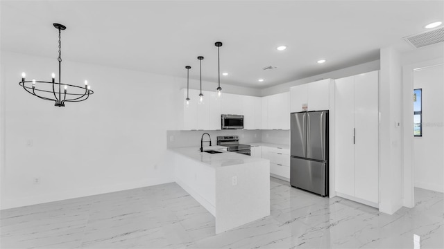 kitchen featuring stainless steel appliances, a peninsula, visible vents, white cabinets, and hanging light fixtures