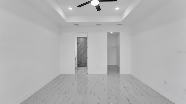 unfurnished room with a tray ceiling, recessed lighting, visible vents, ceiling fan, and baseboards