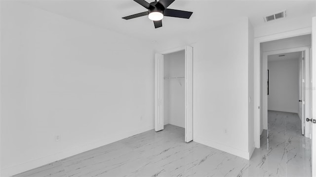 unfurnished bedroom featuring baseboards, visible vents, ceiling fan, marble finish floor, and a closet