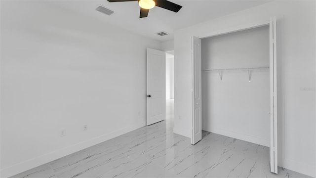 unfurnished bedroom featuring marble finish floor, baseboards, visible vents, and a closet