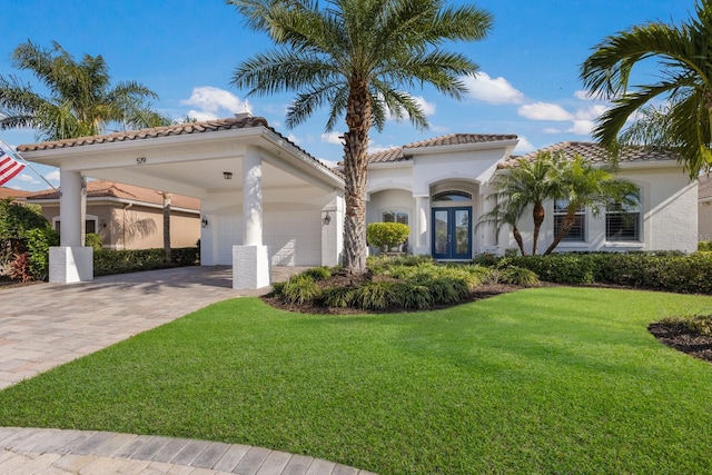 mediterranean / spanish-style house with a garage, a front lawn, and french doors