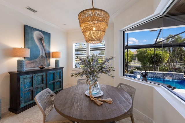 dining space featuring crown molding and a notable chandelier