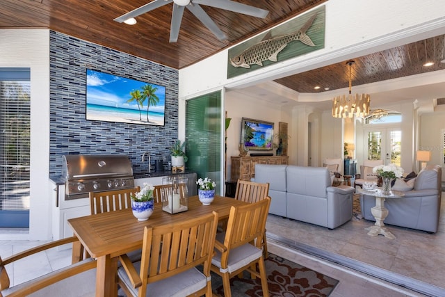 tiled dining room featuring wood ceiling, a raised ceiling, ceiling fan with notable chandelier, and french doors