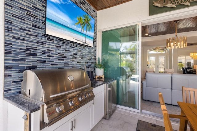 view of patio / terrace featuring an outdoor kitchen and a grill