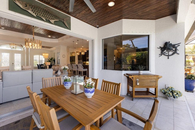 dining area with light tile patterned flooring, an inviting chandelier, wood ceiling, and french doors