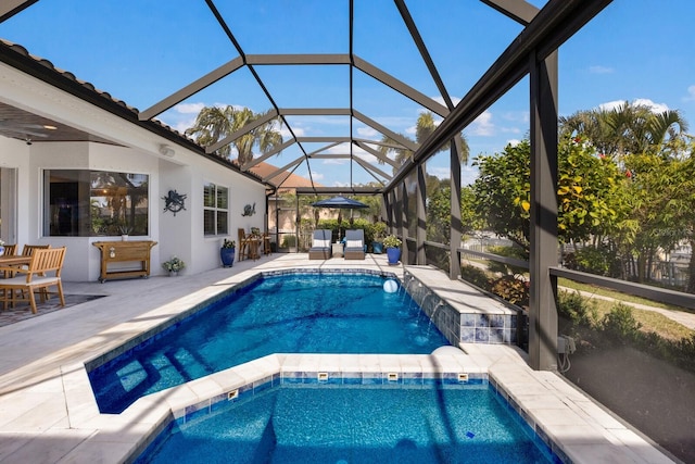 view of pool featuring a lanai, a patio, and pool water feature