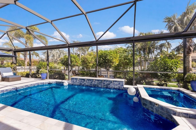 view of pool featuring an in ground hot tub, pool water feature, and glass enclosure