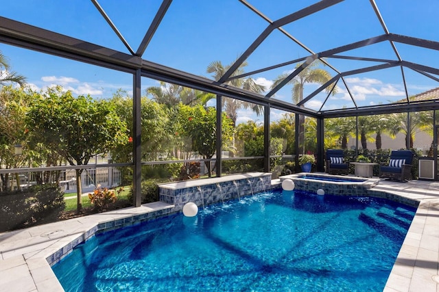 view of swimming pool with an in ground hot tub, pool water feature, a patio, and glass enclosure