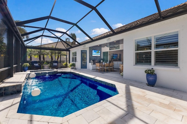 view of swimming pool with pool water feature, glass enclosure, and a patio area