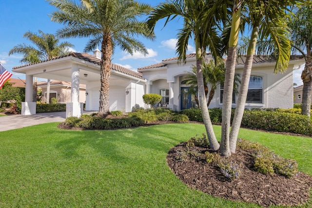 mediterranean / spanish-style house featuring a front lawn