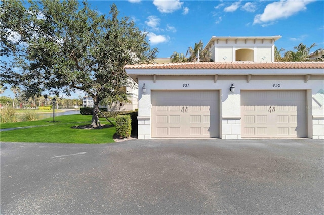 view of front facade with a garage and a front lawn