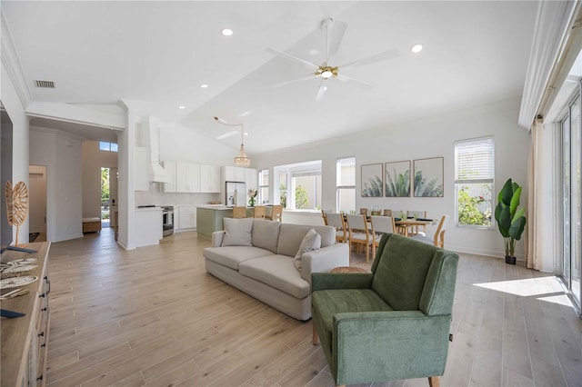 living room featuring ornamental molding, a healthy amount of sunlight, ceiling fan, and light hardwood / wood-style floors