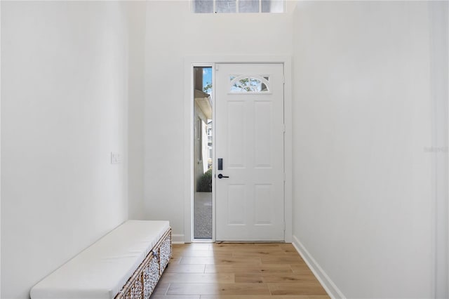 foyer with visible vents, light wood-style floors, and baseboards