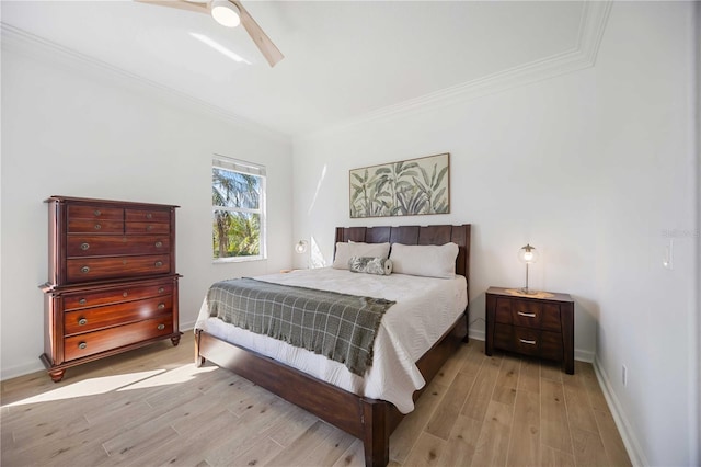 bedroom featuring ornamental molding, ceiling fan, and light hardwood / wood-style flooring