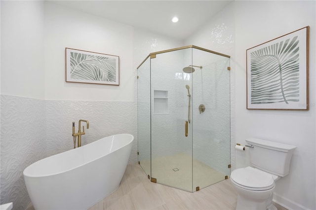 full bath featuring recessed lighting, a soaking tub, a shower stall, and toilet