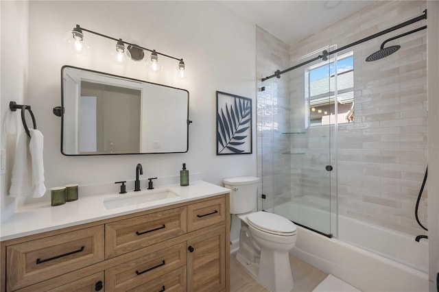 full bathroom featuring vanity, toilet, and bath / shower combo with glass door