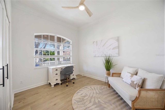 home office with crown molding, baseboards, light wood finished floors, and ceiling fan