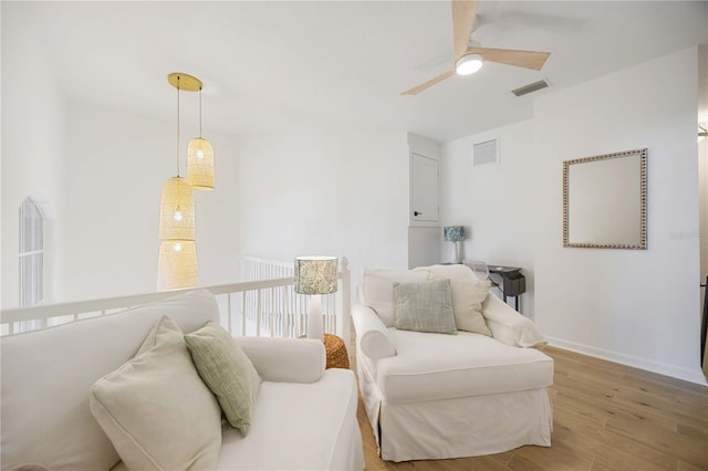 living area featuring ceiling fan and hardwood / wood-style floors