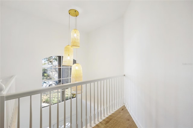 corridor with hardwood / wood-style flooring