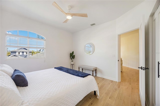 bedroom with ceiling fan and light wood-type flooring