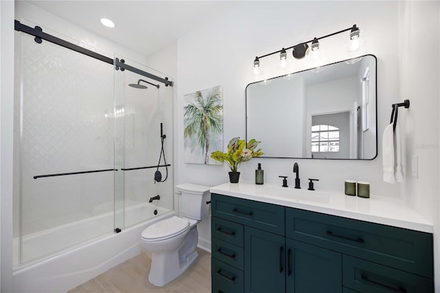 full bathroom with vanity, combined bath / shower with glass door, and toilet