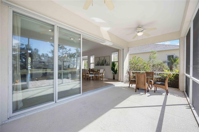 sunroom featuring ceiling fan