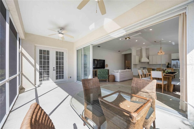 sunroom / solarium featuring french doors, ceiling fan, and vaulted ceiling