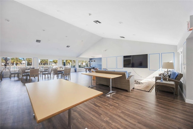 living room featuring dark hardwood / wood-style floors, high vaulted ceiling, and a wealth of natural light