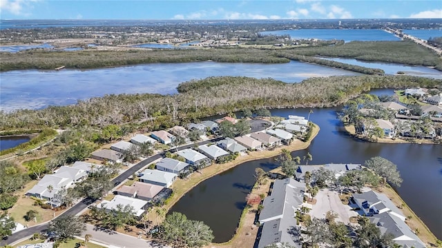 drone / aerial view featuring a water view and a residential view