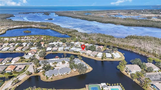 drone / aerial view with a residential view and a water view