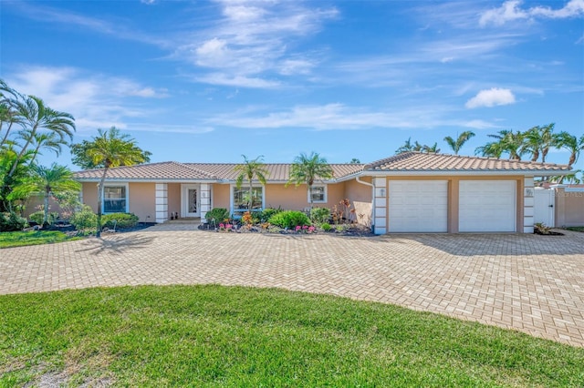 ranch-style home with a garage and a front yard