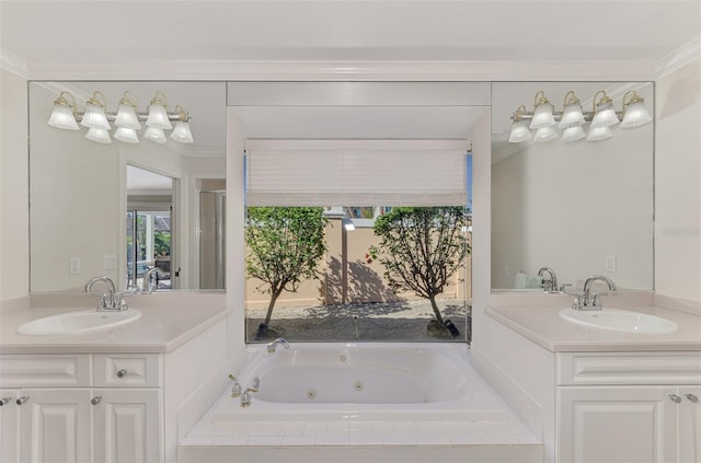 bathroom featuring ornamental molding, vanity, and tiled bath