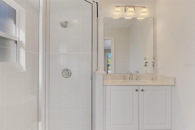 bathroom featuring vanity and a shower with shower door