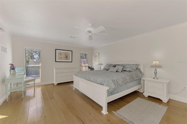 bedroom featuring hardwood / wood-style flooring, ornamental molding, and ceiling fan