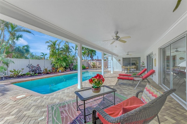 view of pool with ceiling fan and a patio