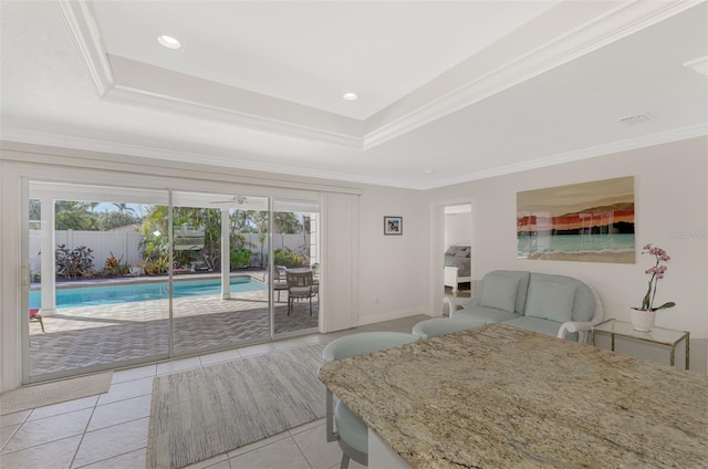 tiled bedroom with crown molding, a tray ceiling, and access to exterior