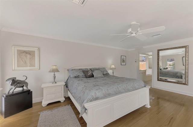 bedroom with ensuite bathroom, ornamental molding, wood-type flooring, and ceiling fan