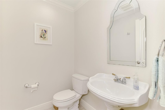 bathroom with crown molding, toilet, and sink